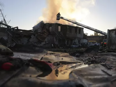 Rescue workers put out a fire at a building destroyed during a Russian strike in Zaporizhzhia, Ukraine, Monday, Sept. 22, 2025. (AP Photo/Kateryna Klochko)