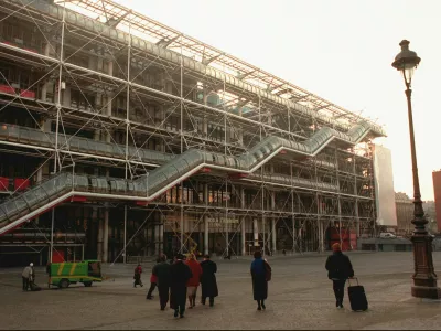 ﻿FILE - People walk in front of the Georges Pompidou Center in Paris on Jan. 28, 1997. Richard Rogers, the lauded British architect who was one of the forces behind the Pompidou Center in Paris and later designed London's Millennium Dome has died. He was 88. Rogers Stirk Harbour + Partners, the company he founded, confirmed his death in a statement Sunday Dec. 19, 2021. (AP Photo/Remy de la Mauviniere, File)