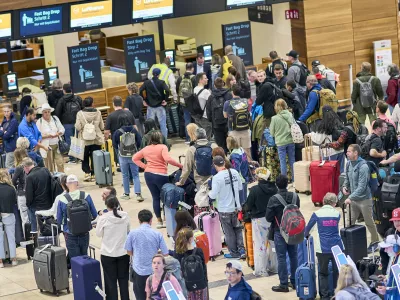 22 September 2025, Brandenburg, Schoenefeld: Passengers are seen in front of the check-in counters in Terminal 1 at Berlin Brandenburg Airport. Passengers are still feeling the effects of a widespread cyberattack on European airports. Photo: Michael Ukas/dpa