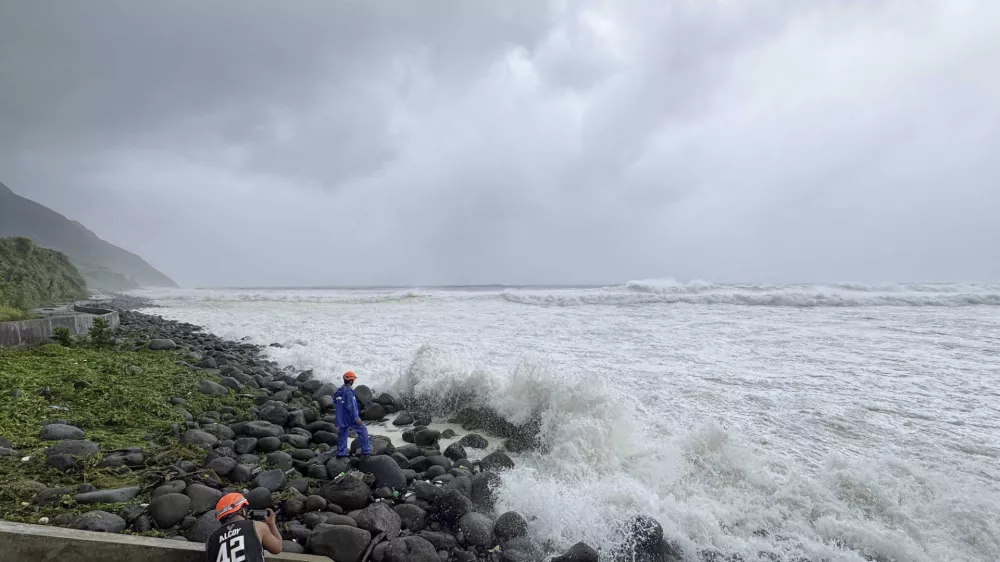 People watch as strong waves batter Basco, Batanes province, northern Philippines as Typhoon Ragasa affects the area on Monday, Sept. 22, 2025. (AP Photo/Justine Mark Pillie Fajardo)
