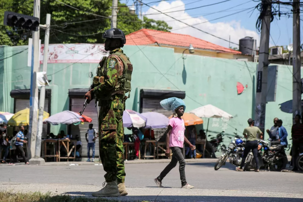 FILE PHOTO: A Kenyan police officer patrols as the country is facing emergency food insecurity while immersed in a social and political crisis, in Port-au-Prince, Haiti October 3, 2024. REUTERS/Jean Feguens Regala//File Photo