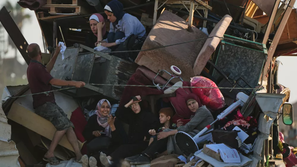 Displaced Palestinians flee northern Gaza Strip, by foot and in vehicles, carrying their belongings along the coastal road, near Wadi Gaza, Tuesday, Sept. 23, 2025. (AP Photo/Abdel Kareem Hana)