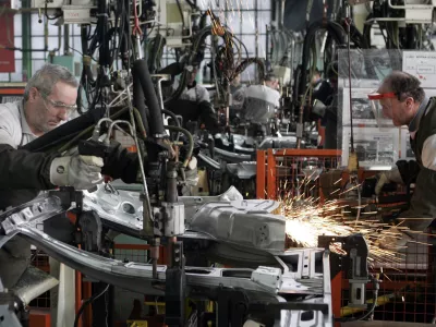Employees work on an assembly line at a Fiat factory in the central Serbian town of Kragujevac, some 120 km (75 miles) south of Belgrade, March 18, 2010. Italy's Fiat has invested 100 million euros out of 700 million euros pledged in Fiat Automobili Srbija, a venture co-held by the Serbian government, designed to establish a car production base in the heart of the EU-hopeful country. REUTERS/Ivan Milutinovic (SERBIA - Tags: BUSINESS TRANSPORT)