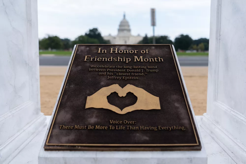A work of protest art representing President Donald Trump and Jeffrey Epstein is seen on the National Mall near the Capitol, Tuesday, Sept. 23, 2025, in Washington. (AP Photo/Julia Demaree Nikhinson)
