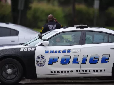 Police block off the street close to a U.S. Immigration and Customs Enforcement office after a reported shooting, in Dallas on Wednesday, Sept. 24, 2025. (AP Photo/Julio Cortez)