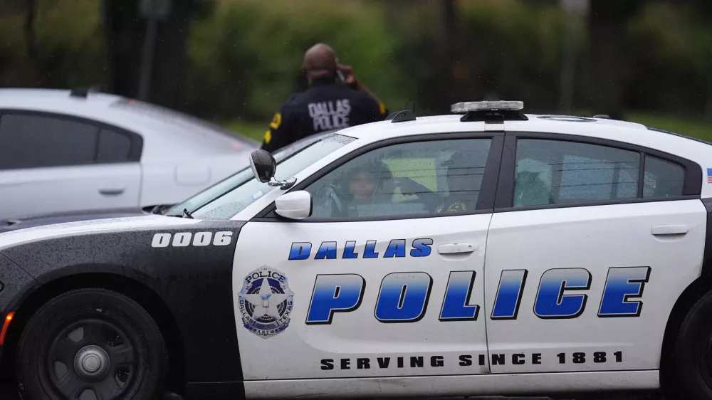 Police block off the street close to a U.S. Immigration and Customs Enforcement office after a reported shooting, in Dallas on Wednesday, Sept. 24, 2025. (AP Photo/Julio Cortez)