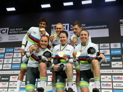 Cycling - Road World Championships 2025 - Kigali, Rwanda - September 24, 2025  Australia's Michael Matthews, Lucas Plapp, Jay Vine, Brodie Chapman, Amanda Spratt and Felicity Wilson-Haffenden celebrate on the podium after winning the team time trial mixed relay REUTERS/Jean Bizimana