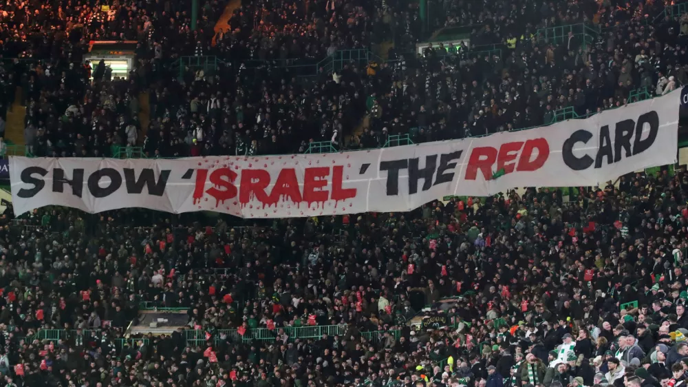 FILE - Celtic fans lift a protest banner about Israel during the Champions League playoff first leg soccer match between Glasgow Celtic and Bayern Munich at the Celtic Park Stadium in Glasgow, Scotland, Wednesday, Feb. 12, 2025. (AP Photo/Scott Heppell, File)