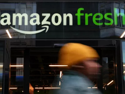 A person walks past an Amazon Fresh convenience grocery store in London, Britain, September 24, 2025. REUTERS/Isabel Infantes