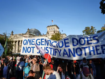 People protest against Israel in front of the German parliament Reichstag during a mass demonstration called "All Eyes on Gaza" in support of Palestinians in Berlin, Germany, Saturday, Sept. 27, 2025. (AP Photo/Christoph Soeder)