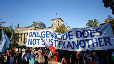 People protest against Israel in front of the German parliament Reichstag during a mass demonstration called "All Eyes on Gaza" in support of Palestinians in Berlin, Germany, Saturday, Sept. 27, 2025. (AP Photo/Christoph Soeder)