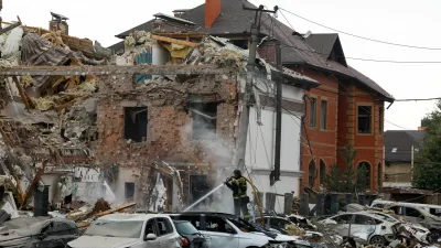 An emergency responder works at an impact site in a residential neighbourhood after Russian drone and missile attacks in Kyiv, Ukraine, September 28, 2025. REUTERS/Thomas Peter