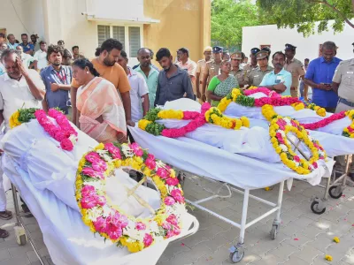 Relatives of people who were killed in a stampede during a rally for a popular Indian actor and politician, mourn as they take the bodies from a hospital, in Karur, in the southern state of Tamil Nadu, Sunday, Sept. 28, 2025. (AP Photo)