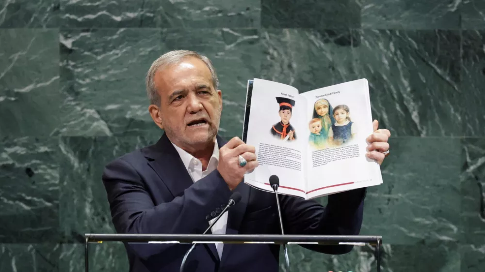 FILE PHOTO: Iran's President Masoud Pezeshkian shows pages of a book as he addresses the 80th United Nations General Assembly (UNGA) at the U.N. headquarters in New York, U.S., September 24, 2025. REUTERS/Jeenah Moon/File Photo