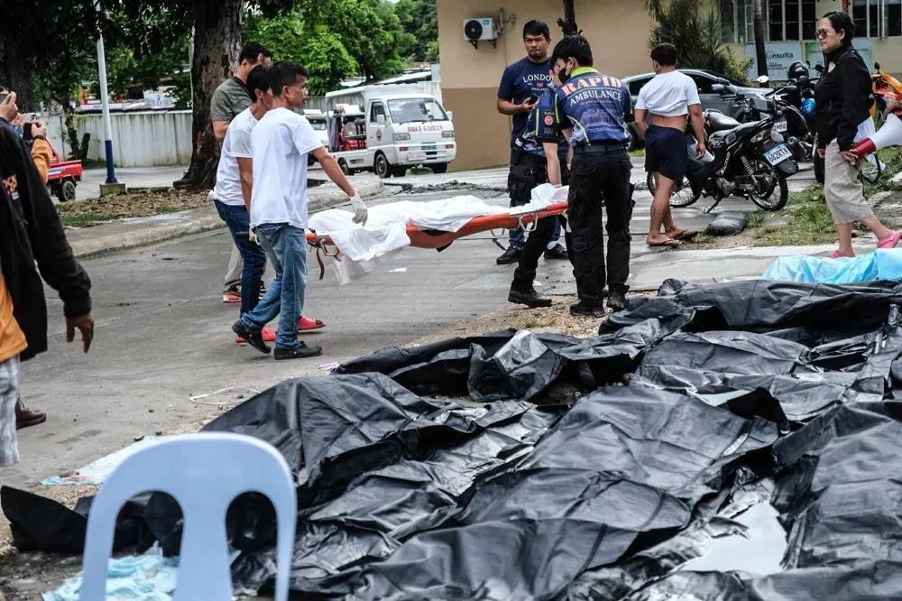 A body on stretcher is carried in Bogo City, Cebu province, Philippines Wednesday, Oct. 1, 2025 after an offshore earthquake on late Tuesday. (AP Photo)