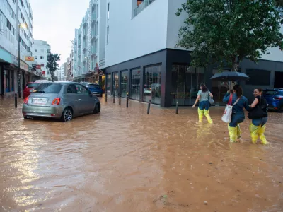 30 September 2025, Spain, Ibiza: People walk along a flooded street in the Balearic city of Ibiza after a heavy rainfall. Photo: Germán Lama/EUROPA PRESS/dpa