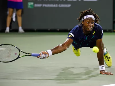 FILE - Gael Monfils, of France, dives as he returns a shot to Milos Raonic, of Canada, at the BNP Paribas Open tennis tournament, Thursday, March 17, 2016, in Indian Wells, Calif. Raonic won 7-5, 6-3. (AP Photo/Mark J. Terrill, File)