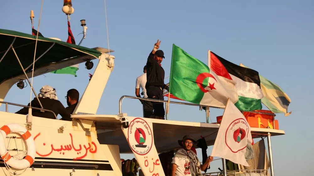 FILE PHOTO: Crew interacts from aboard a boat, part of the Global Sumud Flotilla aiming to reach Gaza and break Israel's naval blockade, as it sails off Koufonisi islet, Greece, September 26, 2025. REUTERS/Stefanos Rapanis/File Photo