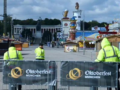 Security stands in front of an Theresienwiese entrance as the Oktoberfest beer festival will remain shut until at least 5 pm (1500 GMT) today, after police said they discovered explosives in a residential building in the north of the city that caught fire and left one person dead in Munich, Germany, October 1, 2025.  REUTERS/Fariha Farooqui