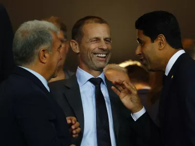 Soccer Football - UEFA Champions League - FC Barcelona v Paris St Germain - Estadi Olimpic Lluis Companys, Barcelona, Spain - October 1, 2025 FC Barcelona president Joan Laporta, UEFA president Aleksander Ceferin and Paris St Germain president Nasser Al-Khelaifi talk in the stands before the match REUTERS/Albert Gea