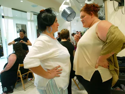 Giovanna Guidoni (R) and Stefania Ugolini chat as they wait for make-up before attending the 16th edition of Italy's Miss Cicciona contest (Italy's Miss Chubby) in Forcoli, central Italy, July 24, 2004. The chubby contest takes place every year in this Tuscan town near Pisa, gathering fat people from all over Italy. According to the main rule, women participants have to weigh at least 100 kg while men at least 150 kg. This 2004 title of Miss Chubby was won by 190Kg weight Giovanna Guidoni. Picture taken July 24. REUTERS/Alessia Pierdomenico AMP/DBP