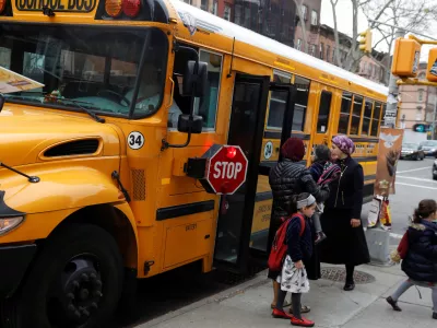 ﻿Orthodox Jewish children get off a Yeshiva school bus, as New York City Mayor Bill de Blasio declared a public health emergency in parts of Brooklyn in response to a measles outbreak, in the Williamsburg neighborhood of Brooklyn in New York City, U.S., April 9, 2019. REUTERS/Shannon Stapleton