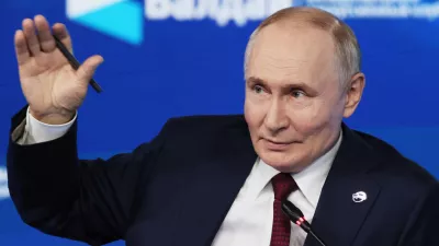Russian President Vladimir Putin gestures as he answers questions during a meeting with foreign policy experts at the Valdai Discussion Club in the Black Sea resort of Sochi, Russia, on Thursday, Oct. 2, 2025. (Mikhail Metzel, Sputnik, Kremlin Pool Photo via AP)