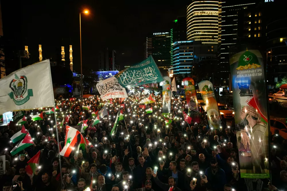 People gather in front of the Israel consulate during a protest against the interception of the Gaza-bound Sumud flotilla by Israeli navy forces, in Istanbul, Thursday, Oct. 2, 2025. (AP Photo/Emrah Gurel)