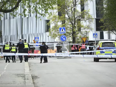 Police at the scene after a shooting incident, at Vaksala Square, in central Uppsala, Sweden, Tuesday, April 29, 2025. (Fredrik Sandberg/TT News Agency via AP)
