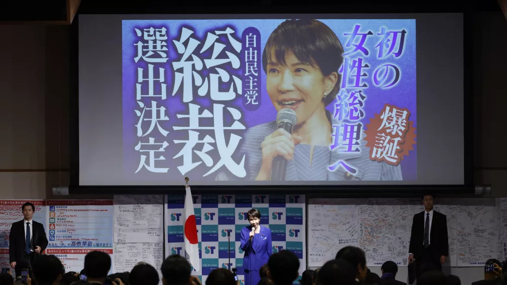 Newly elected leader of the Liberal Democratic Party (LDP) Sanae Takaichi, center, speaks during a gathering afte the LDP's leadership election in Tokyo Saturday, Oct. 4, 2025. The words read " Toward the first female prime minister. Selected as the LDP's leader. " (Haruna Furuhashi/Kyodo News via AP)