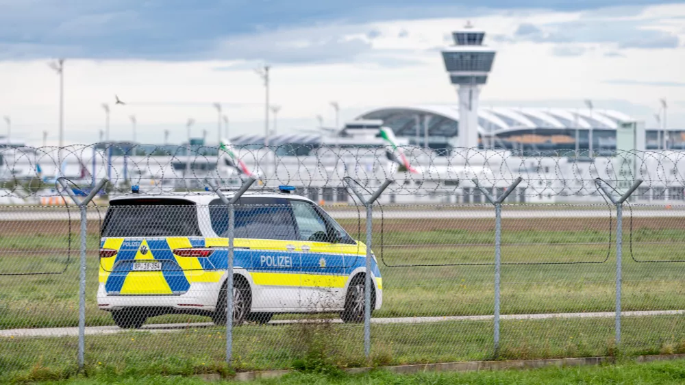04 October 2025, Bavaria, Munich: A police vehicle drives on the grounds of Munich Airport. After sightings of drones, flight operations were resumed on Saturday morning. Photo: Armin Weigel/dpa