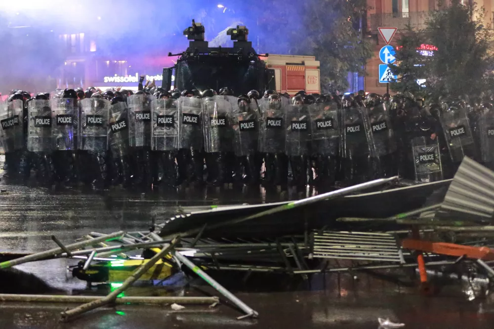 Police block a street to prevent demonstrators from advancing during an opposition rally in the city center of Tbilisi, Georgia, on Saturday, Oct. 4, 2025, as they boycott the municipal elections and call for the release of political opponents. (AP Photo/Zurab Tsertsvadze)
