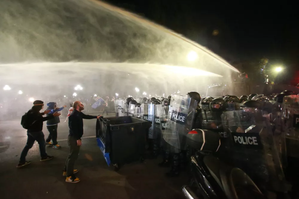 Police use a water cannon to block protesters during an opposition rally in the city center of Tbilisi, Georgia, on Saturday, Oct. 4, 2025, boycotting the municipal elections and call for the release of political opponents. (AP Photo/Zurab Tsertsvadze)