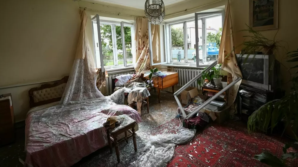 Shattered glass on the floor inside a room of a house damaged during a Russian drone and missile strike, amid Russia's attack on Ukraine, in the village of Lapaivka on the outskirts of Lviv, Ukraine October 5, 2025. REUTERS/Stringer