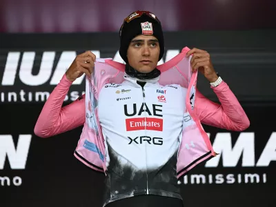 Cycling - Giro d'Italia - Stage 14 - Treviso to Nova Gorica - Slovenia - May 24, 2025 UAE Team Emirates's Isaac Del Toro puts on the maglia rosa jersey after stage 14 REUTERS/Jennifer Lorenzini