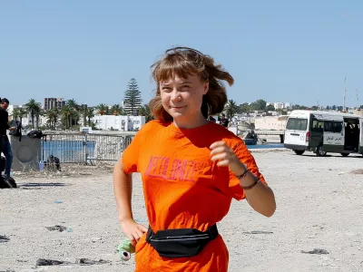 Swedish activist Greta Thunberg, a member of the Global Sumud Flotilla, walks as the flotilla waits to set sail towards Gaza, with other boats from Tunisia, as part of an international humanitarian aid initiative to break Israel's naval blockade and deliver vital supplies to Palestinians, at the port of Bizerte, Tunisia September 13, 2025. REUTERS/Zoubeir Souissi   TPX IMAGES OF THE DAY