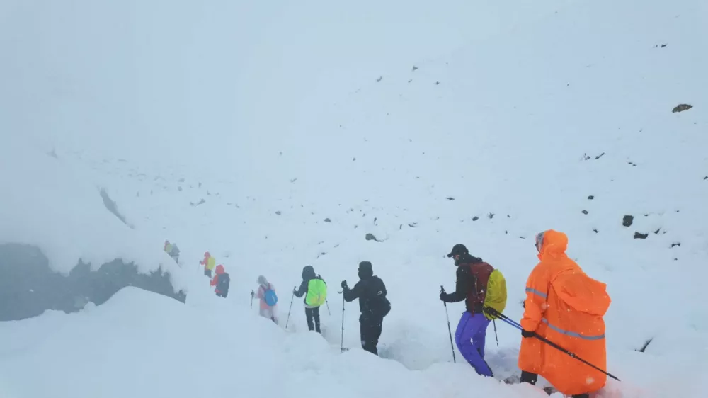 A screen capture from video shows trekkers leaving their campsite, as unusually heavy snow and rainfall pummeled the Himalayas, in the Tibet Region, China, October 5, 2025. Geshuang Chen/Handout via REUTERS. THIS IMAGE HAS BEEN SUPPLIED BY A THIRD PARTY NO RESALES. NO ARCHIVES. MANDATORY CREDIT