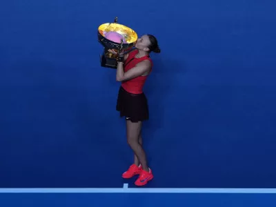 Amanda Anisimova, of the United States kisses the trophy after winning the women's singles final match against Linda Noskova, of the Czech Republic, in the China Open tennis tournament, at the National Tennis Center, in Beijing, Sunday, Oct. 5, 2025. (AP Photo/Andy Wong)