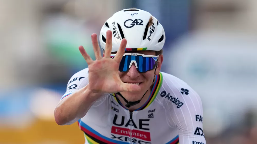 Reigning World Champion Tadej Pogacar indicates five as he celebrates winning his fifth in a row Il Lombardia, Tour of Lombardy cycling race, in Bergamo, Italy, Saturday, Oct. 11, 2025. (Gian Mattia D'Alberto/LaPresse via AP)