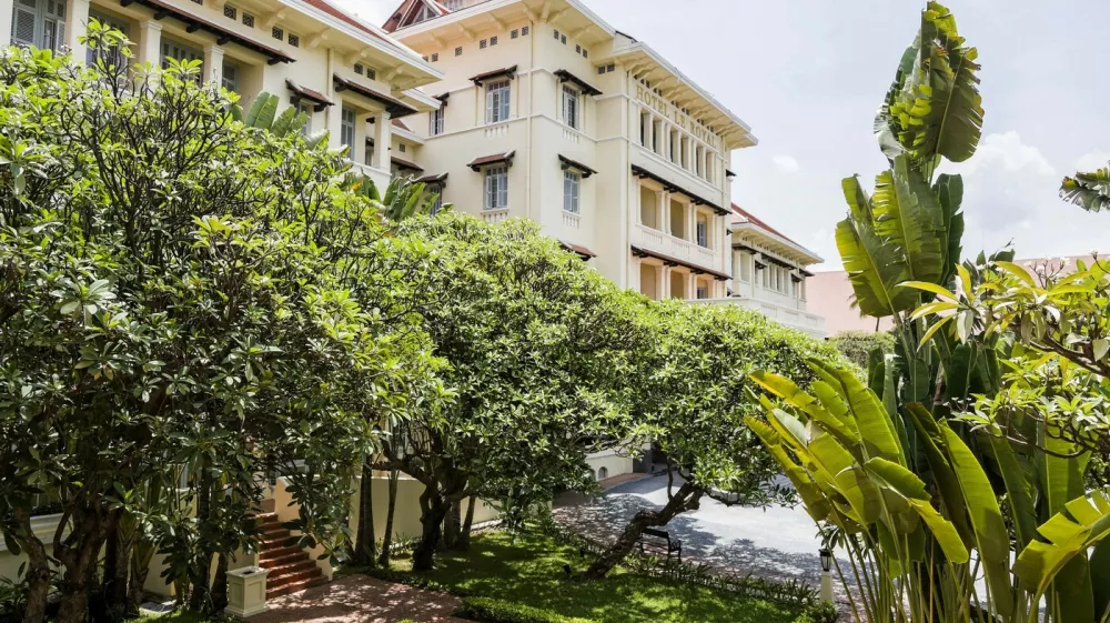 Phnom Penh's Raffles Hotel Le Royal is one of Asia's great classic hotels. Its elegant French colonial building, with cool black and white tiled floors, a dark teak staircase, high ceilings, louvered shutters and overhead fans, is an artistic statement of Khmer, Art Deco and French style. Originally opened in 1929, and re-opened in 1997, after a sympathetic extension and refurbishment by Raffles Hotels Fresh Takeo River Lobster Amok with Coconut Milk; Long Hours Braised Lamb Shanks in a Star Anise and Palm Sugar Sauce, with Stir Fried KaiLan (Chinese Broccoli) and Crispy Rice.,Image: 260087142, License: Rights-managed, Restrictions:, Model Release: no