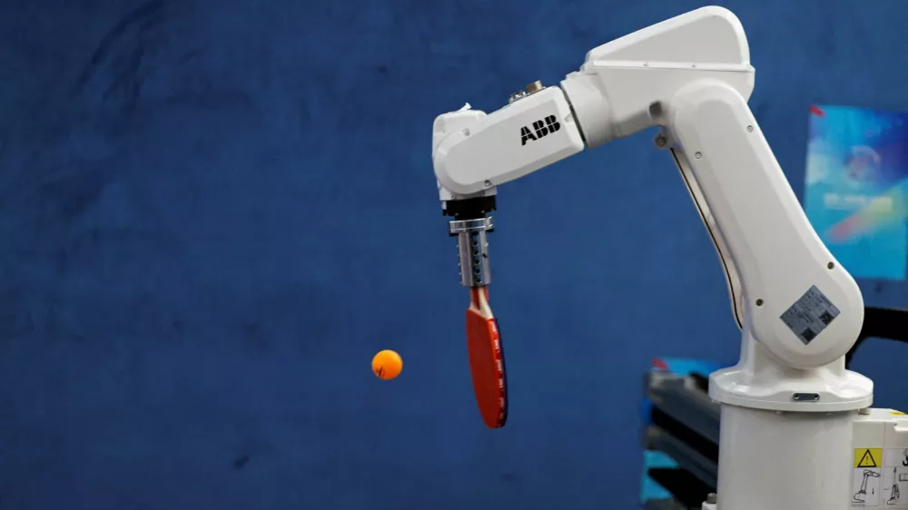 FILE PHOTO: An ABB robotic arm takes part in a table tennis competition at the inaugural World Humanoid Robot Games, at the National Speed Skating Oval in Beijing, China August 15, 2025. REUTERS/Tingshu Wang/File Photo
