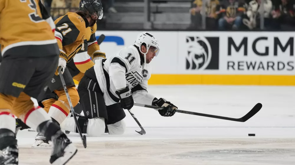 Los Angeles Kings center Anze Kopitar (11) passes against the Vegas Golden Knights during the first period of an NHL hockey game Wednesday, Oct. 8, 2025, in Las Vegas. (AP Photo/John Locher)