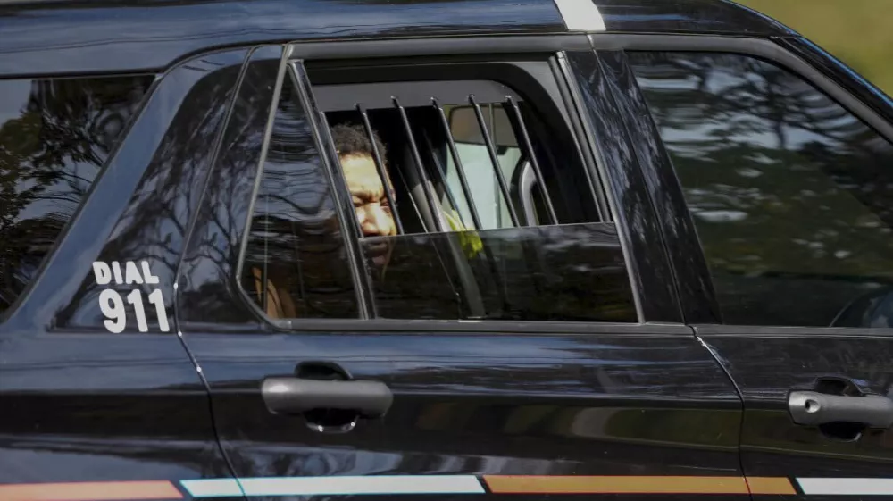 Derrick Groves, the last escapee from the New Orleans jailbreak in May, sits in a police vehicle after being taken into custody by U.S. Marshals and Atlanta police at a southwest Atlanta home, Wednesday, Oct. 8, 2025. (Ben Hendren/Atlanta Journal-Constitution via AP)