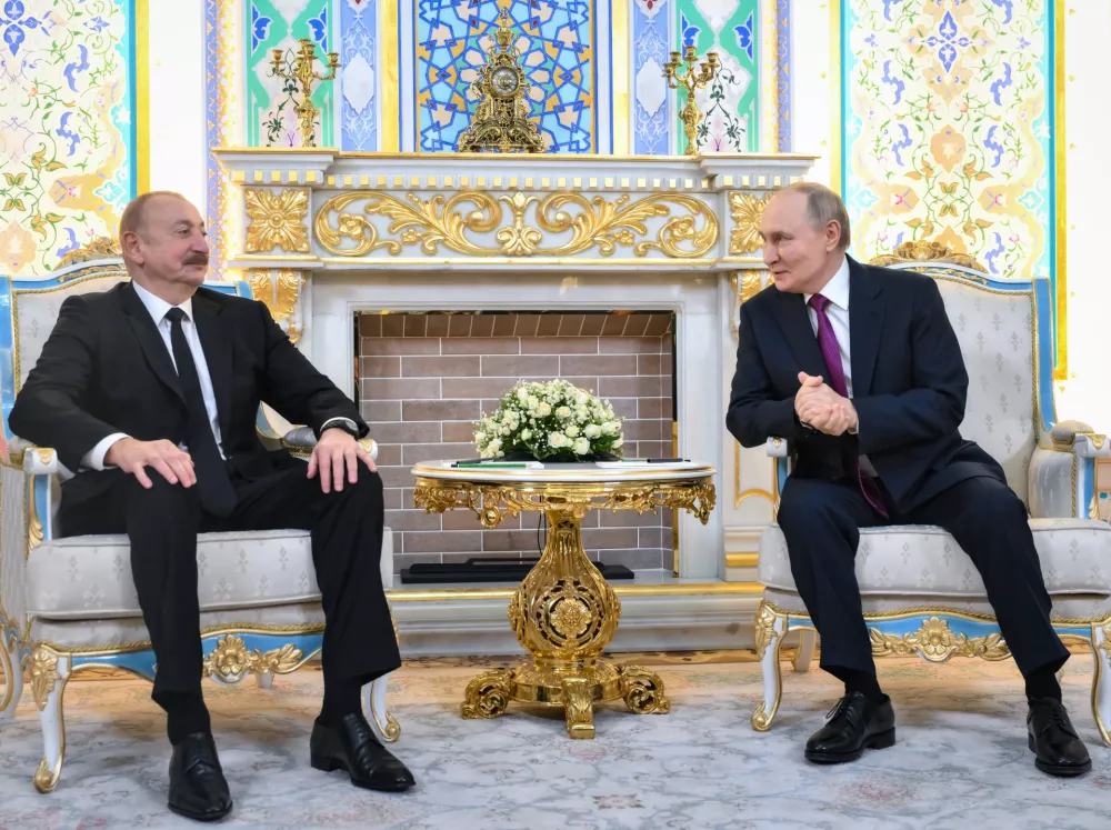 Russian President Vladimir Putin, right, and Azerbaijan's President Ilham Aliyev talk during their meeting on the sidelines of the Russia-Central Asia summit in Dushanbe, Tajikistan, on Thursday, Oct. 9, 2025. (Grigory Sysoyev, Sputnik, Kremlin Pool Photo via AP)