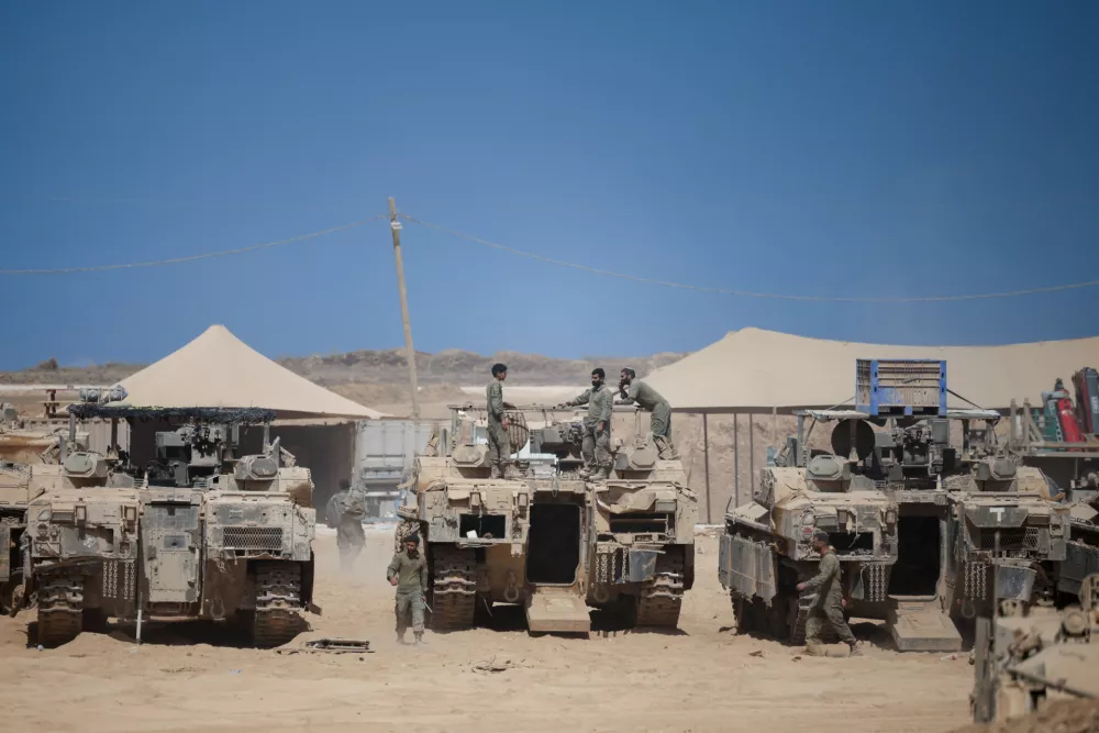 Israeli soldiers stand on top of an armoured personnel carrier (APC) near the Israel-Gaza border, after a ceasefire between Israel and Hamas in Gaza went into effect, in Israel, October 10, 2025. REUTERS/Shir Torem