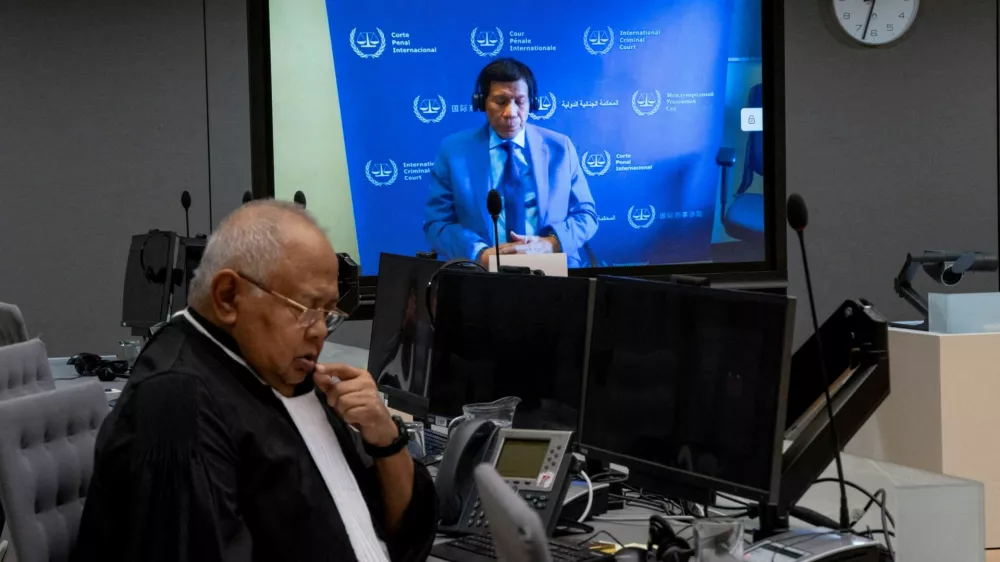 FILE PHOTO: Former Philippine President Rodrigo Duterte is seen on a screen in the courtroom of the International Criminal Court (ICC) with his lawyer Salvador Medialdea seated left, in The Hague, Netherlands, Friday, March 14, 2025. Peter Dejong/Pool via REUTERS//File Photo