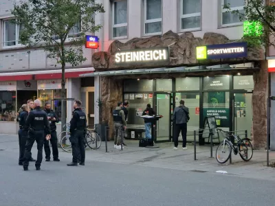 11 October 2025, Giessen: Police officers stand at the market square in Giessen after an unknown person opened fire, injuring several people, according to a police spokesperson. Three people were injured in central Giessen on Saturday after shots were fired in a betting shop, a police spokesman said. Photo: Carolin Eckenfels/dpa