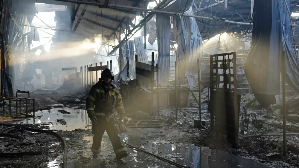 A firefighter works inside the burned-out Sigma shopping mall following yesterday evening's Ukrainian military strike, in the course of Ukraine-Russia conflict in Donetsk, a Russian-controlled city of Ukraine, October 12, 2025. REUTERS/Alexander Ermochenko