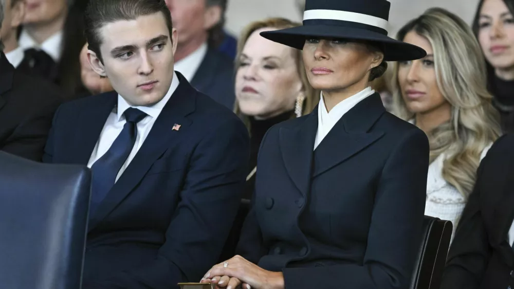 Barron Trump and first lady Melania Trump listen as President Donald Trump delivers remarks after being sworn in during the 60th Presidential Inauguration in the Rotunda of the U.S. Capitol in Washington, Monday, Jan. 20, 2025. (Saul Loeb/Pool photo via AP)
