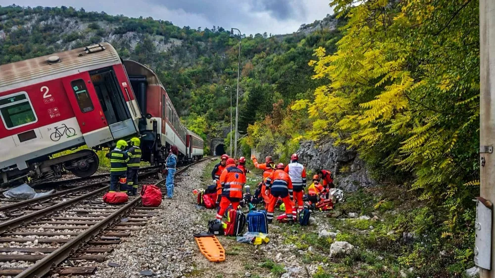 In this photo released by Slovak Police, rescue workers treat wounded passengers after a train crash near Roznava, Slovakia, Monday, Oct. 13, 2025. (Slovak Police via AP)
